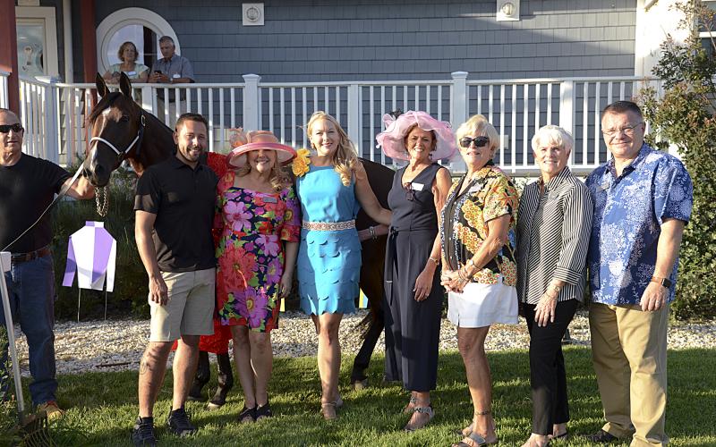 Trainer Pete Marsh holds Changing TIdes for Children’s Beach House event committee members. Shown are (l-r) Marketing Manager Justin Nixon; Karen Bowers Falk, event chair; Cheryl Crowe, event co-chair; Pat Tosi; Connie Miller; Linda Fischer; and CBH Executive Director Rich Garrett.